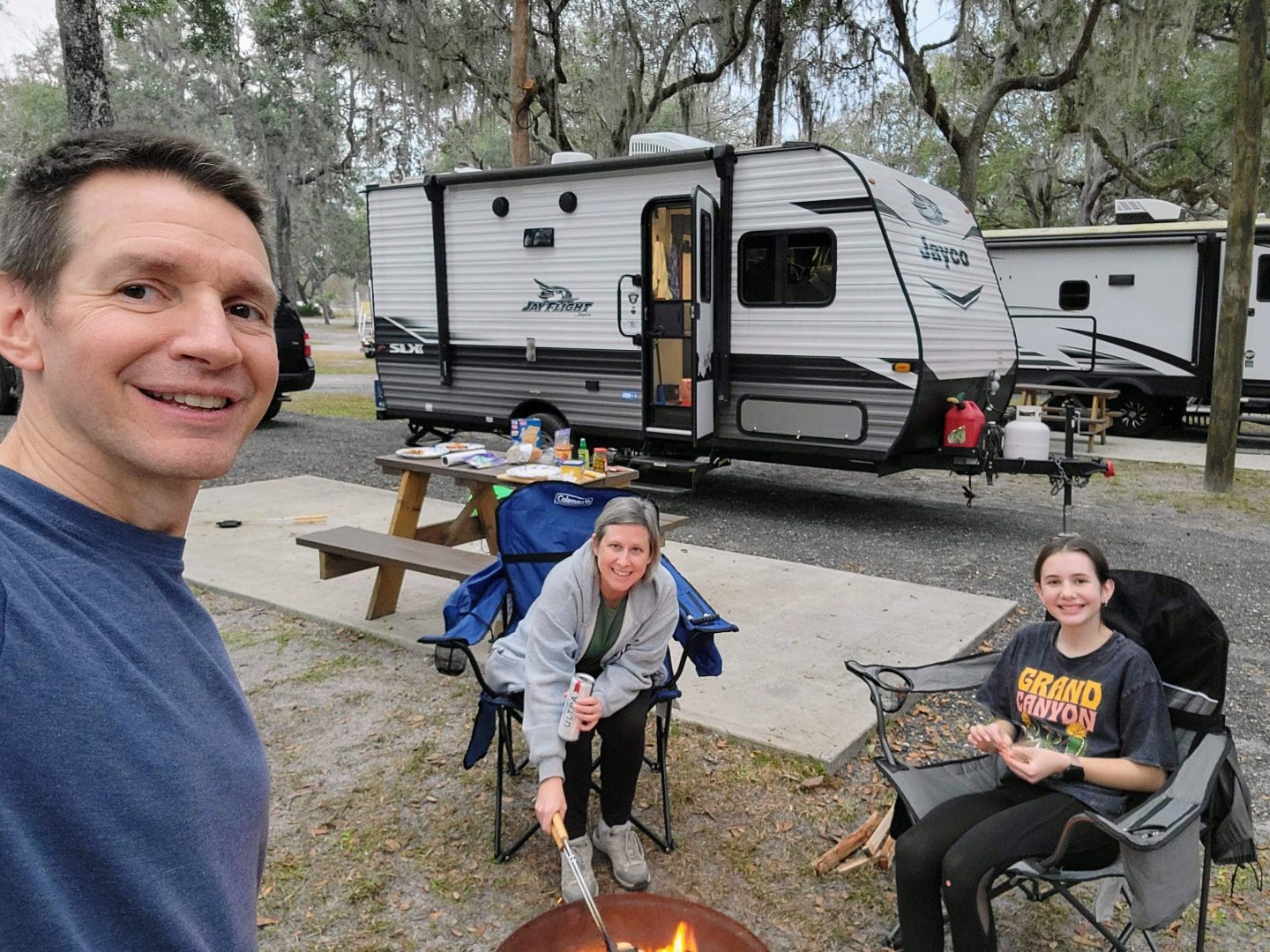 Photo shows Jim White and his wife, Lisa, and daughter, Faith, camping in their RV.