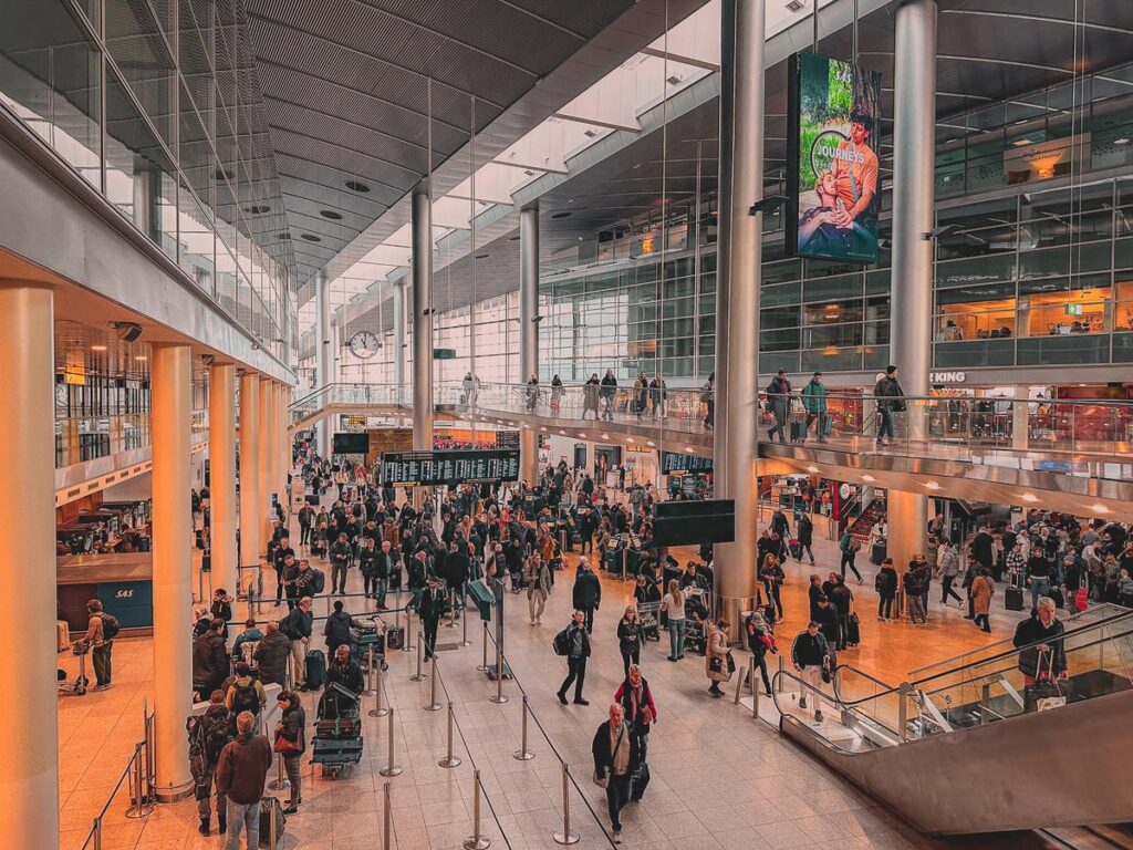 Bustling Copenhagen Airport Terminal - Modern architecture, travelers, sRGB color photography, Journeys advertisement