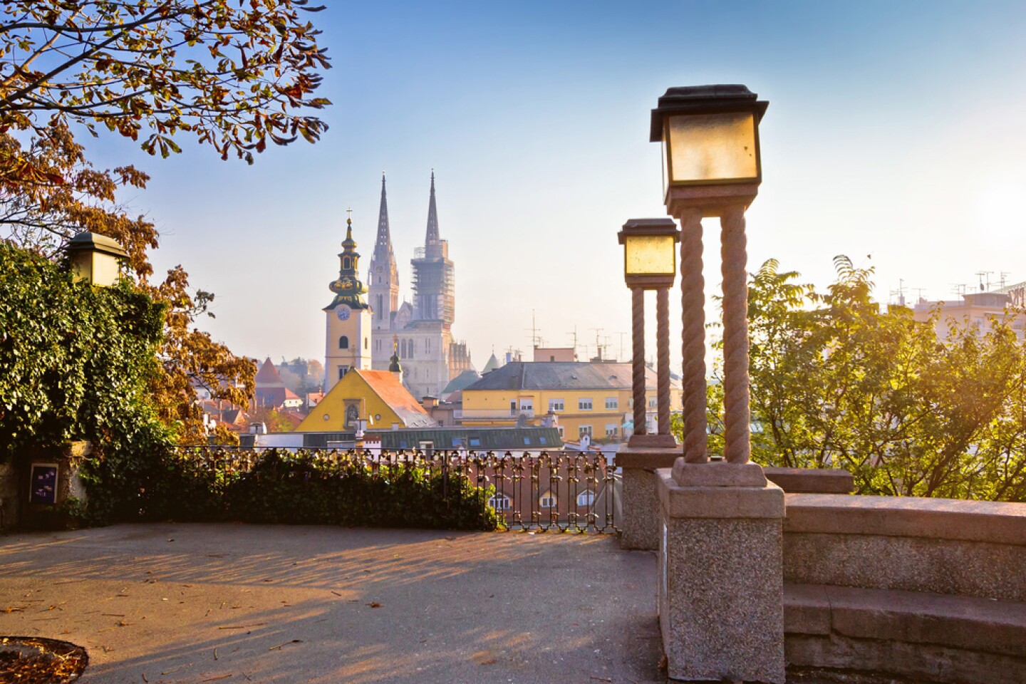 Stone patio with towers and other historical city buildings in the distance 