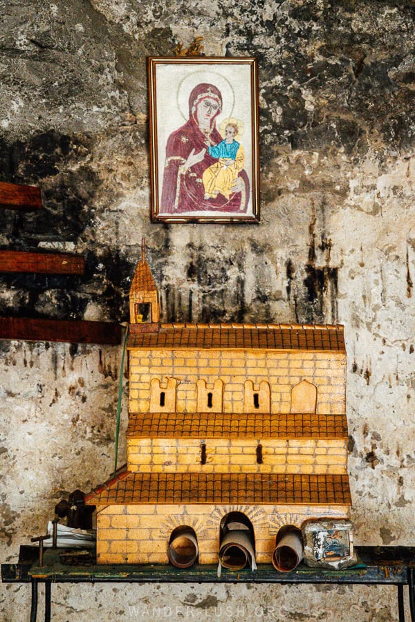A miniature version of the church in Vazisubani, with icons and votive candles.