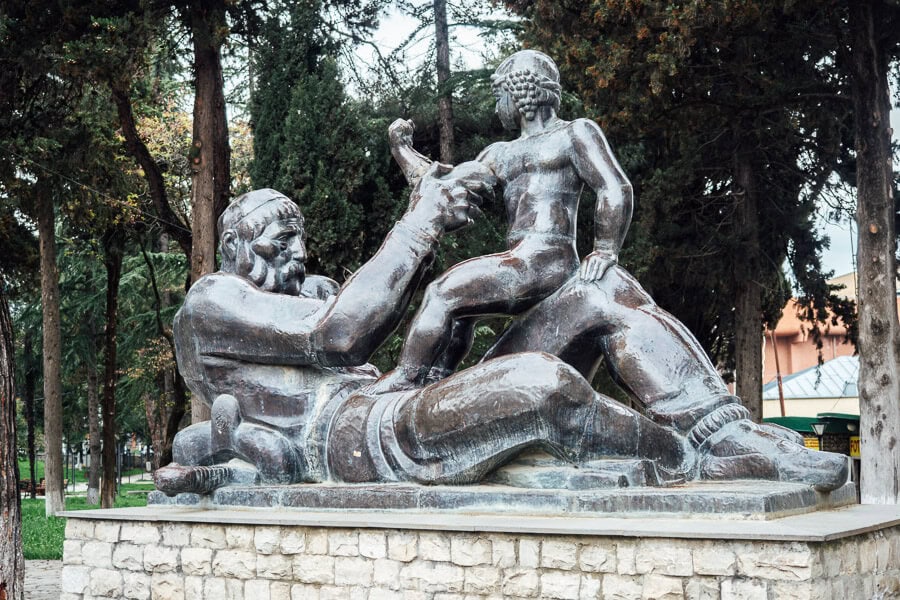 A metal sculpture depicting a grandfather and a child at the entrance to Papas Baghi garden in Gurjaani.