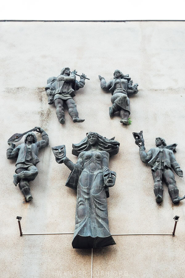 Five metal sculptures depicting the muses on the facade of the Gurjaani Cultural Centre, former Palace of Culture.
