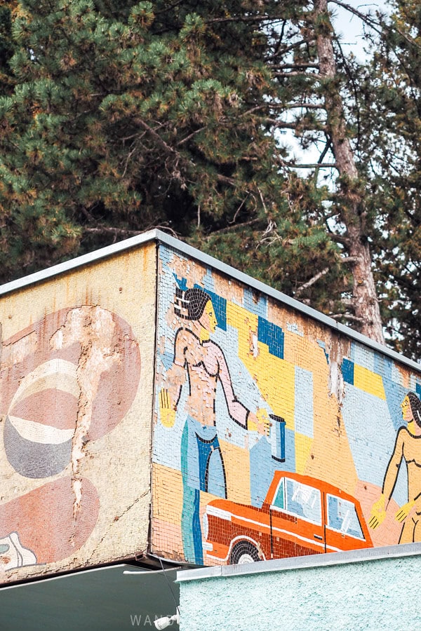 A Soviet mosaic in Georgia with a retro red car.