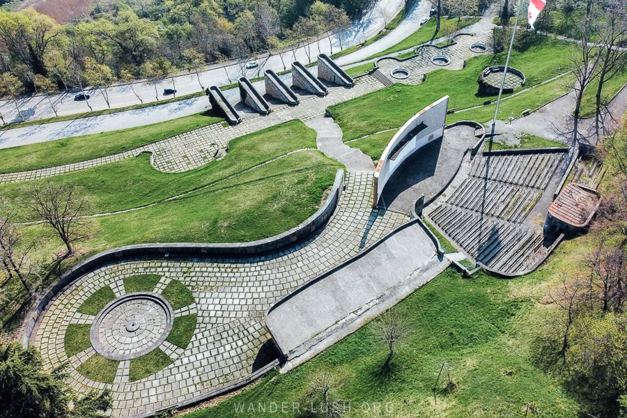 An aerial view of the Gurjaani Memorial of Glory, a massive WWII memorial complex with an eternal flame.
