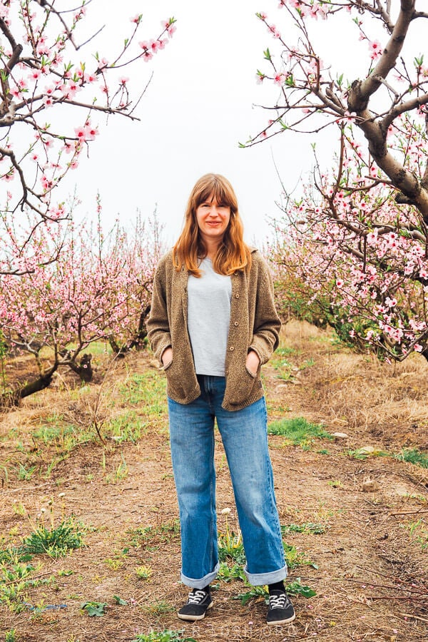 Emily standing in front of the peach trees in Gurjaani.