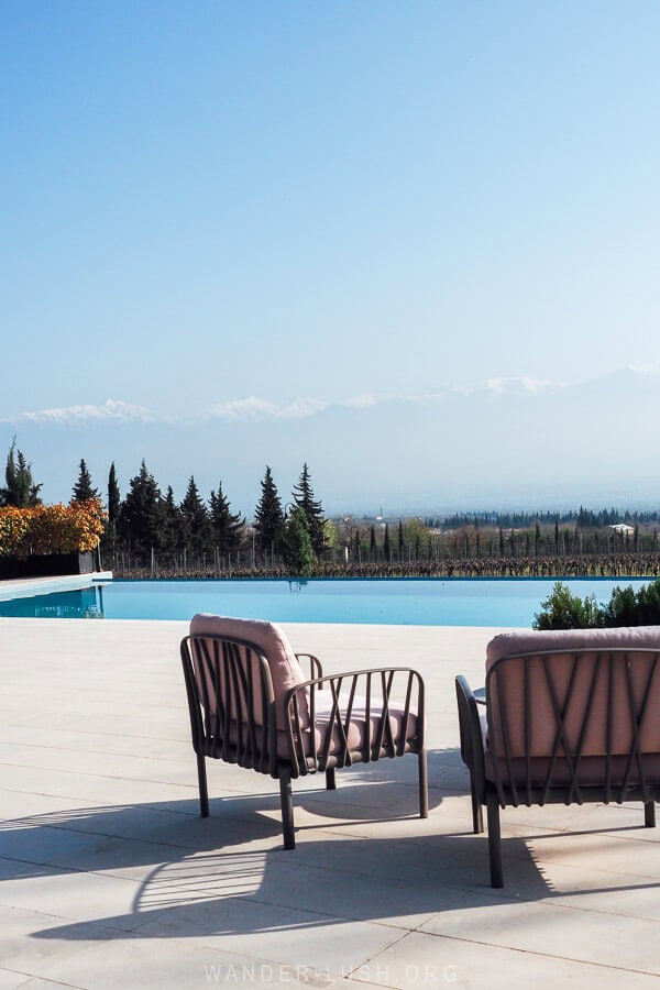 View of the Greater Caucasus mountains and a swimming pool at Vazisubani Estate.