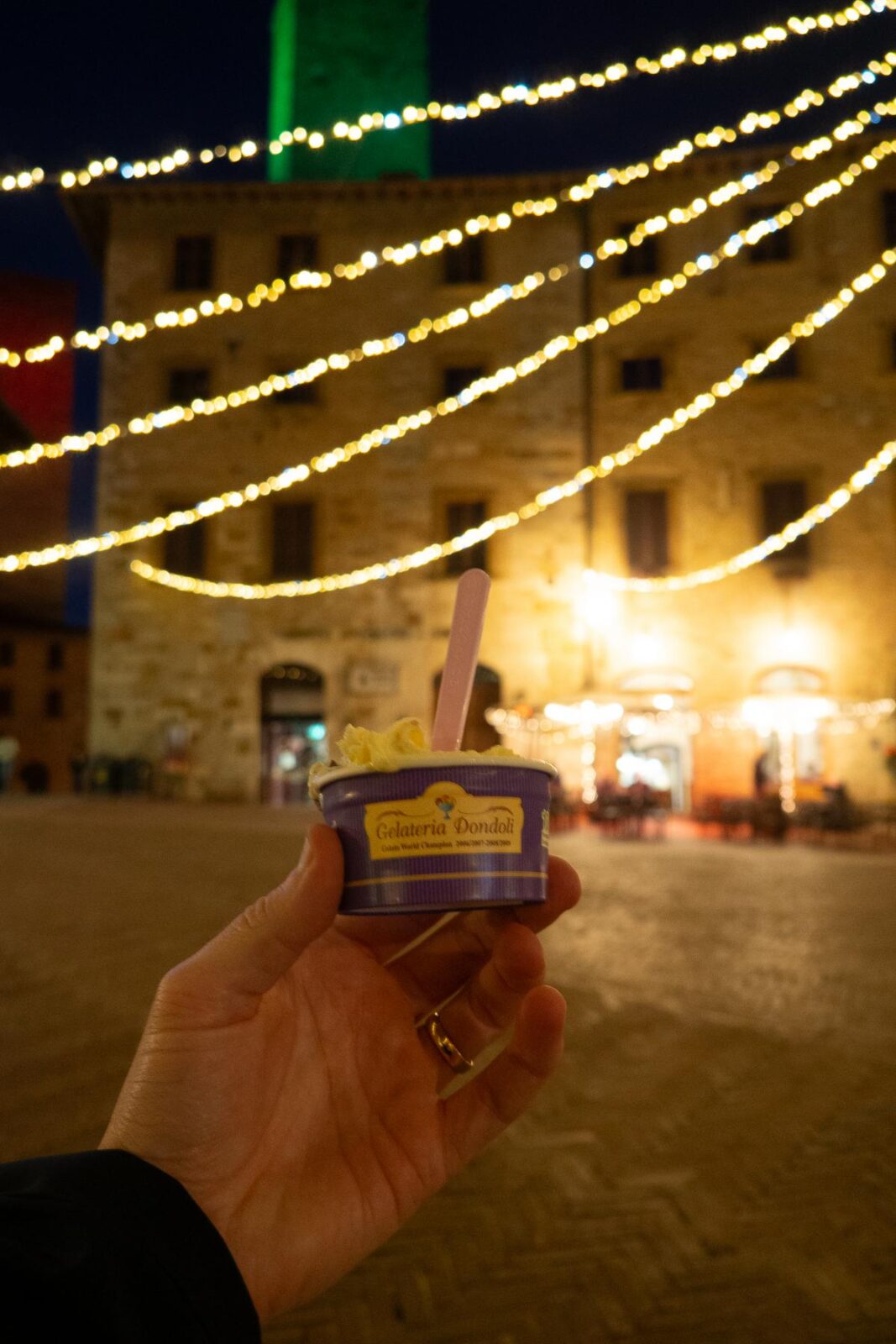 Enjoying Gelateria Dondoli gelato at night in San Gimignano Piazza