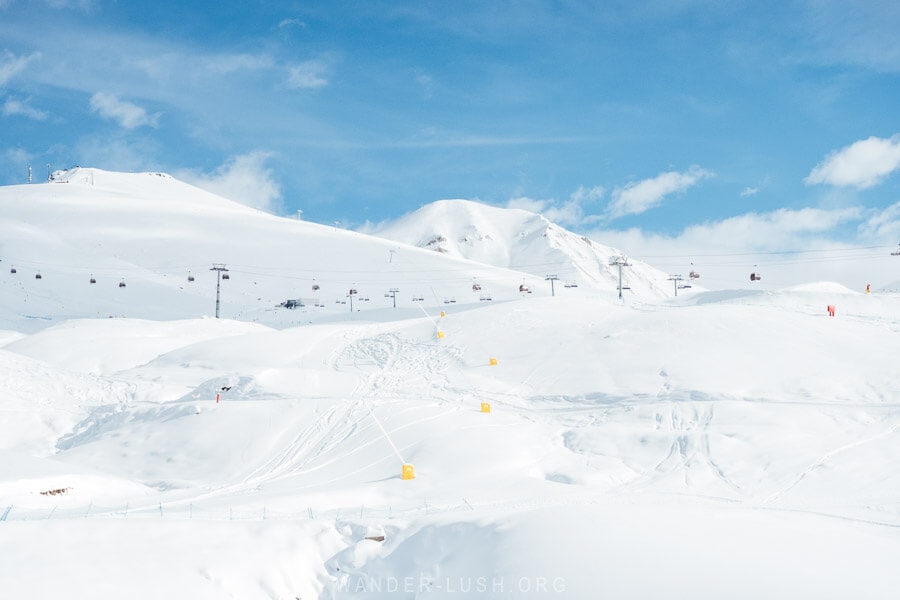 Lifts criss cross a white mountain at the Gudauri ski resort in Georgia.