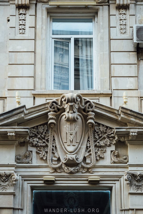 A mansion house in Baku with the former owners' initials engraved above the doorway.