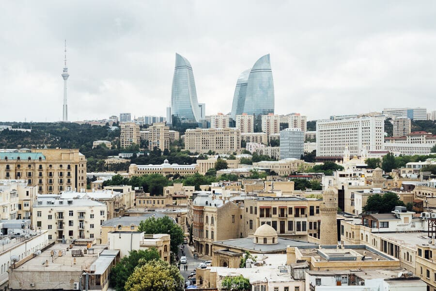 A panoramic city view of Baku, with mosques, Soviet-style apartment buildings and contemporary architecture.
