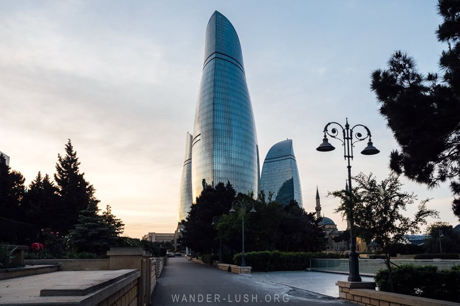 Martyrs' Lane, a war cemetery in Baku, Azerbaijan with the modern Flame Towers high-rise buildings rising up in the distance.
