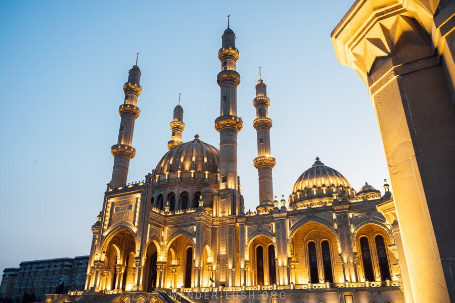 They Heydar Mosque, an ornate mosque with four minarets in Baku illuminated at night.