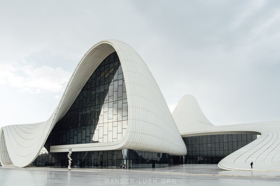They Heydar Aliyev Centre, a white modern building with curved lines and glass walls in Baku Azerbaijan.