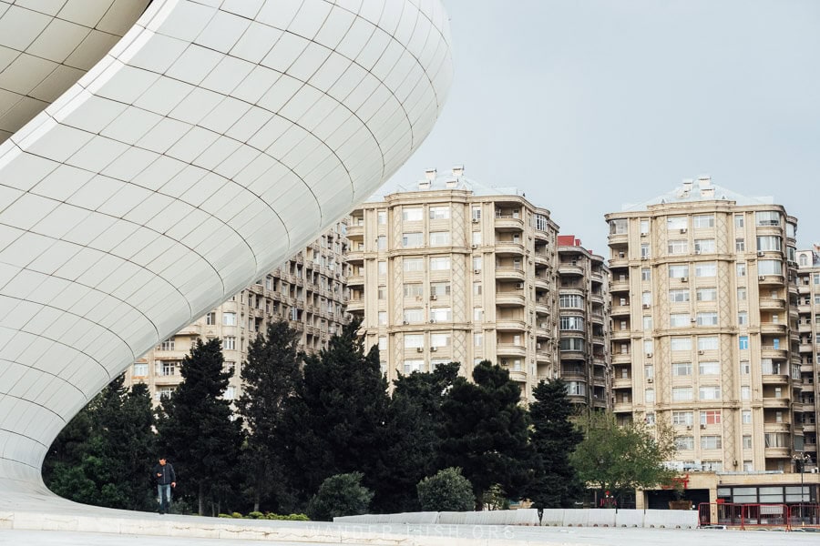 The Heydar Aliyev Centre, a contemporary building in Baku, Azerbaijan with a backdrop of apartment buildings.