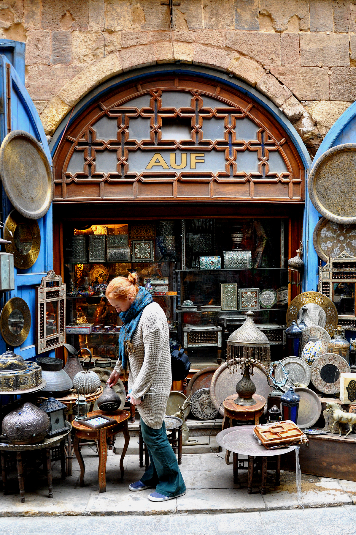 Dee looks over a souvenir stand in Khan El Khalili selling metal lanterns and wooden boxes.