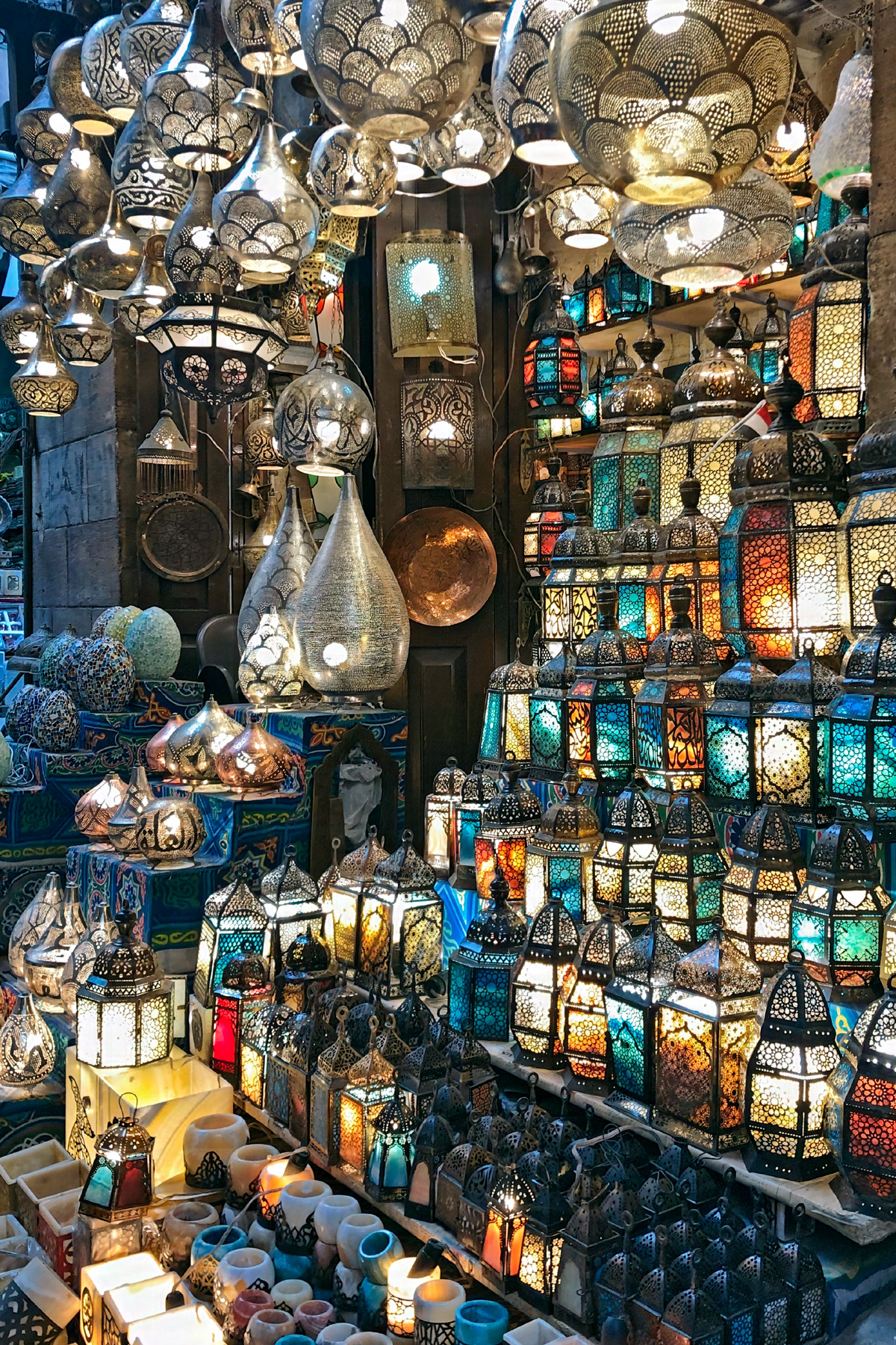 Elaborate lanterns piled high and lit in colors of blue, orange and red at a shop in Khan el Khalili.