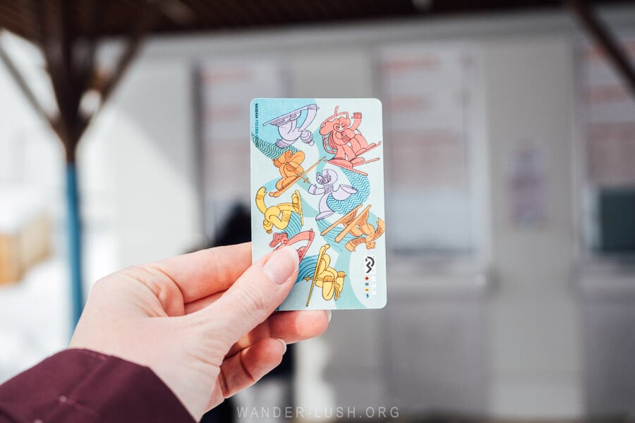 A hand holding up a ski lift pass for Gudauri in Georgia.