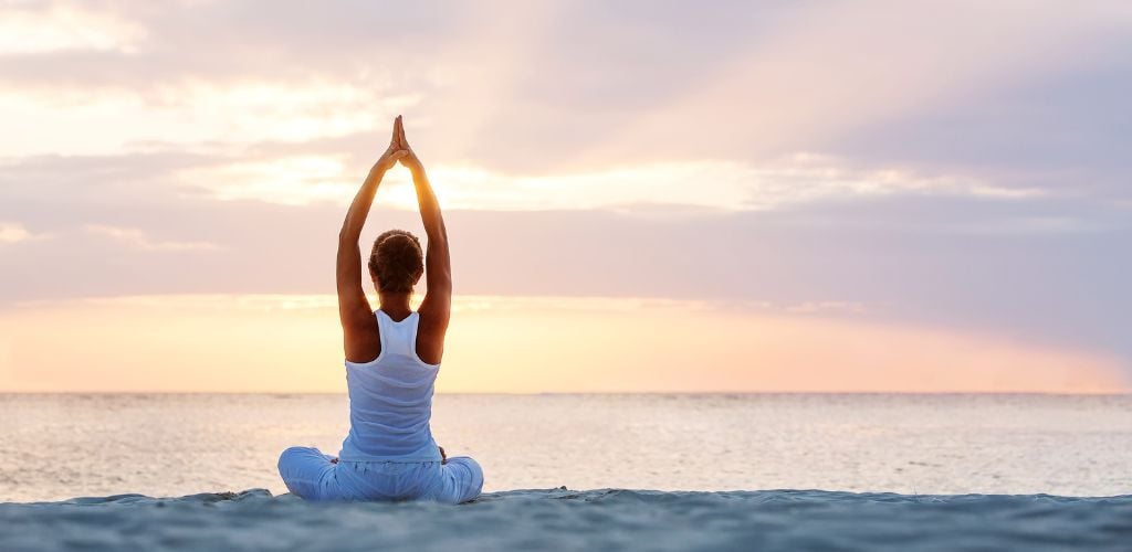 Doing Yoga on The Beach at Sunrise in Tulum