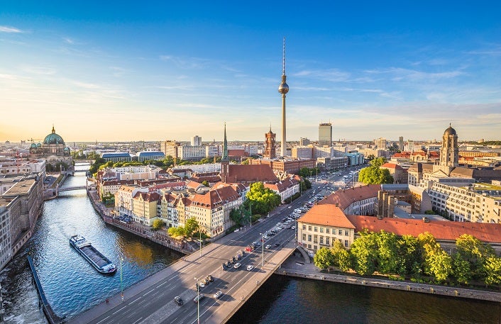 Berlin skyline panorama with TV tower and Spree river at sunset,