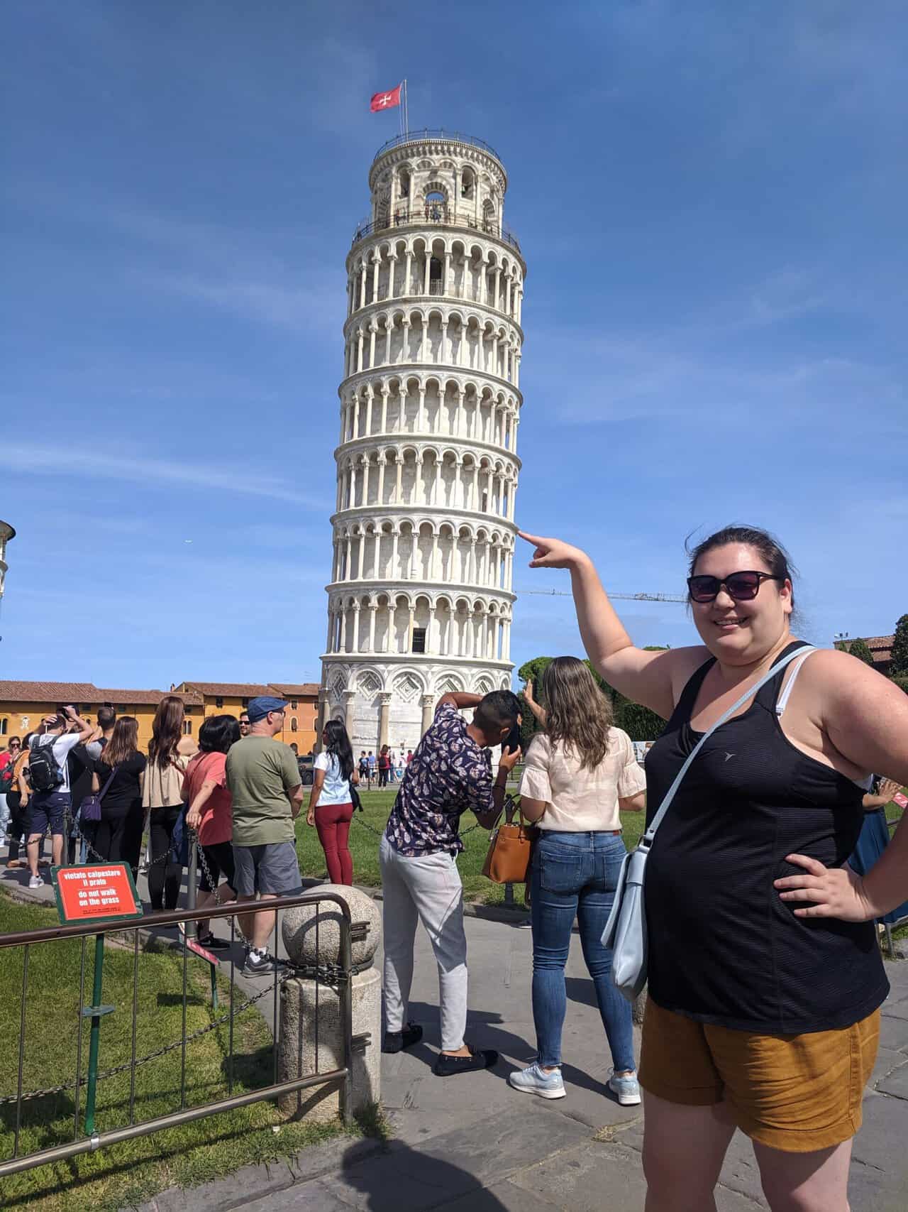 Riana posing next to the Leaning Tower of Pisa in Italy