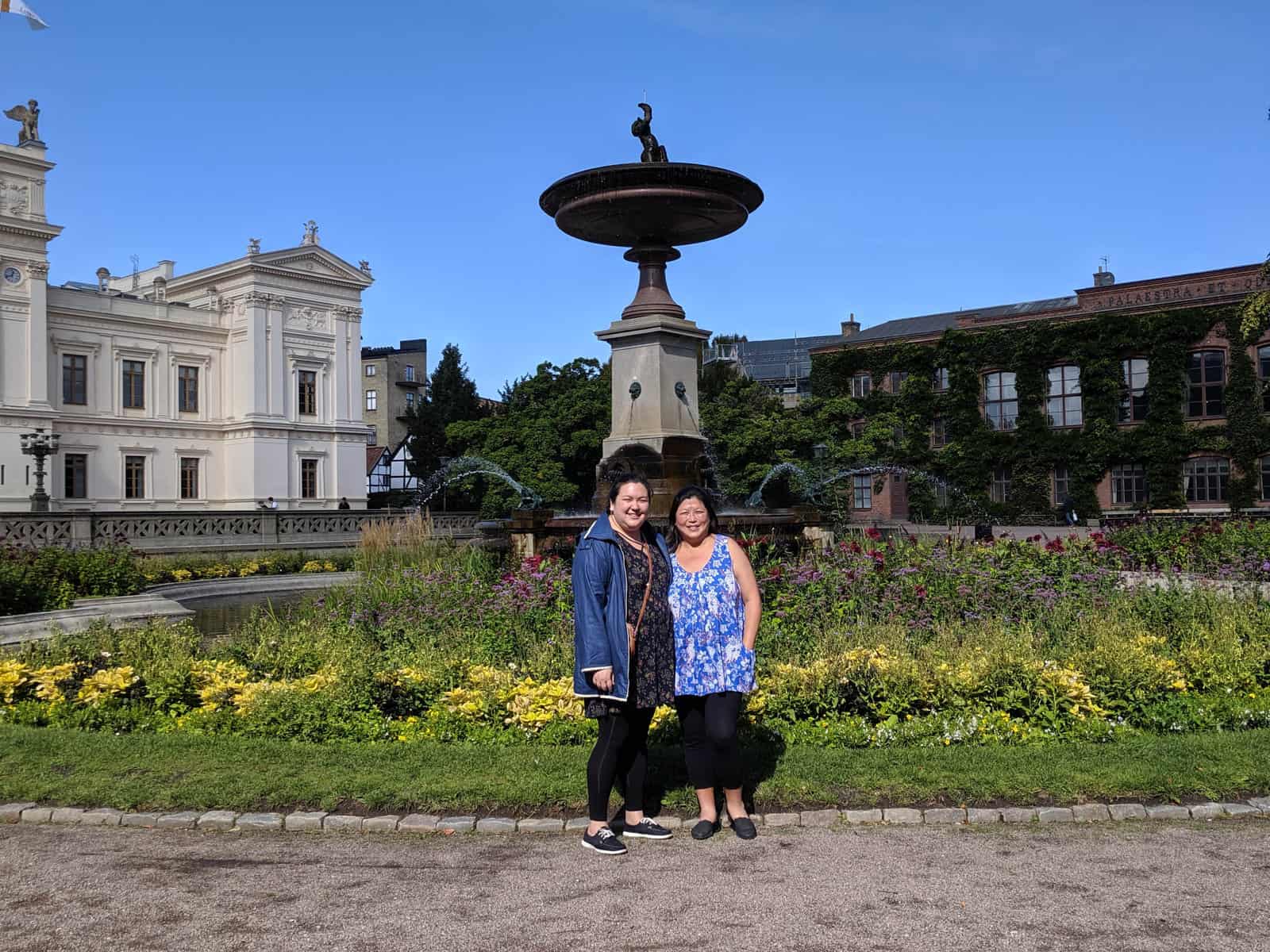 Riana and her mom posing in front of a fountain in Lund, Sweden