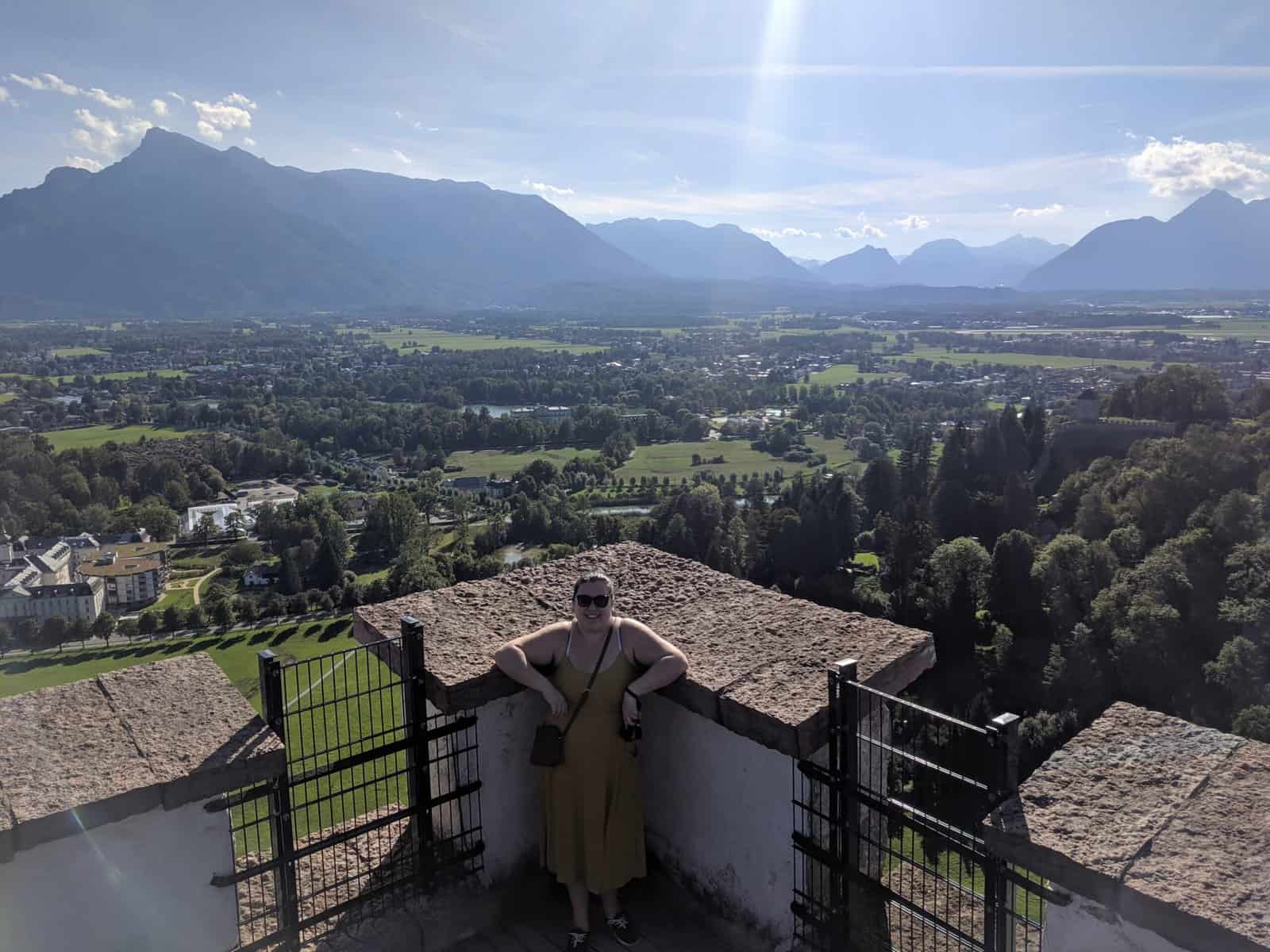 Riana standing in front of a view of Salzburg from the Hohensalzburg Fortress