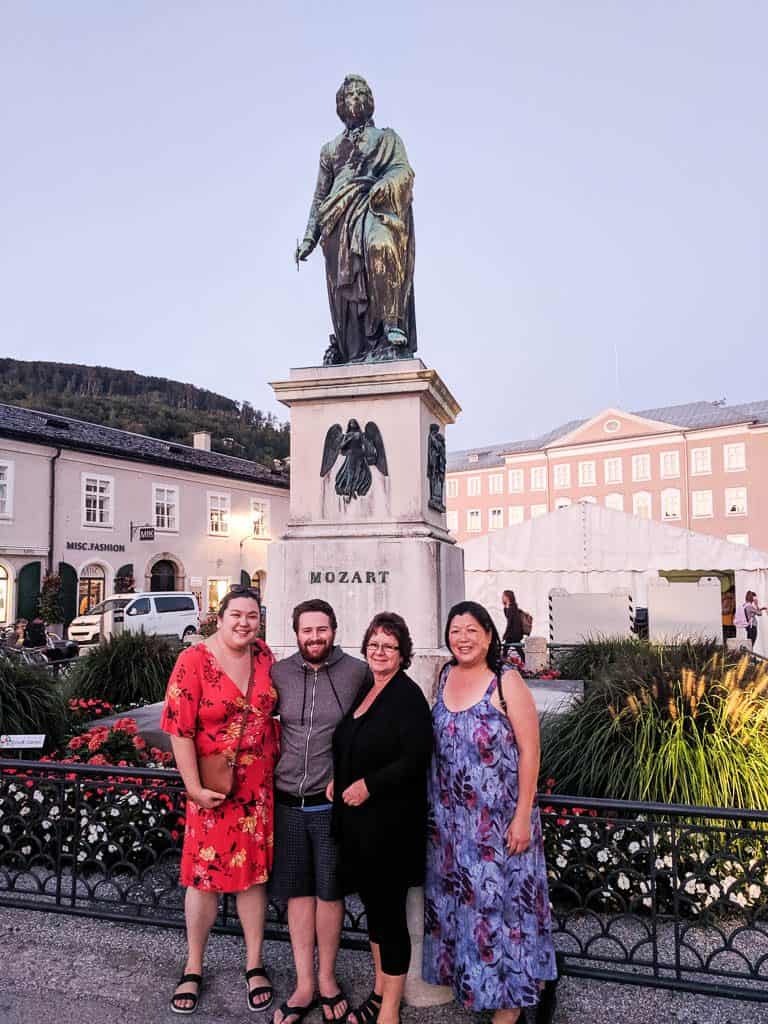 Posing with our moms in Salzburg Old Town in front of a  Mozart statue