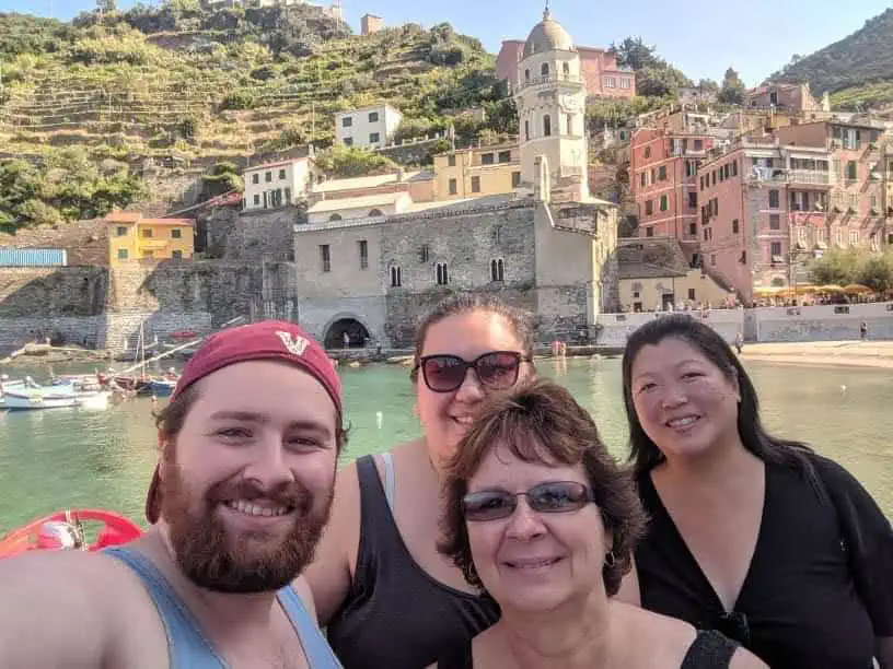 Selfie of Riana, Colin and their moms on the dock in Vernazza, Italy