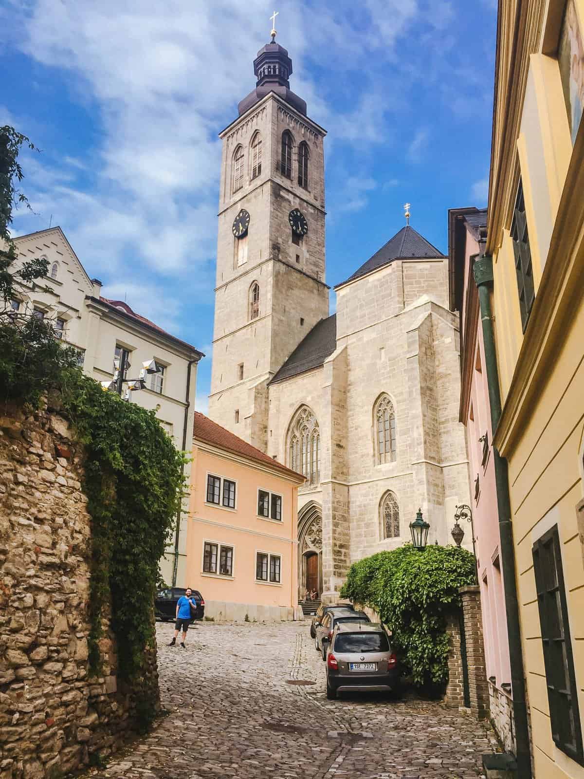 Cobblestone streets of Kutna Hora with buildings and a clock tower