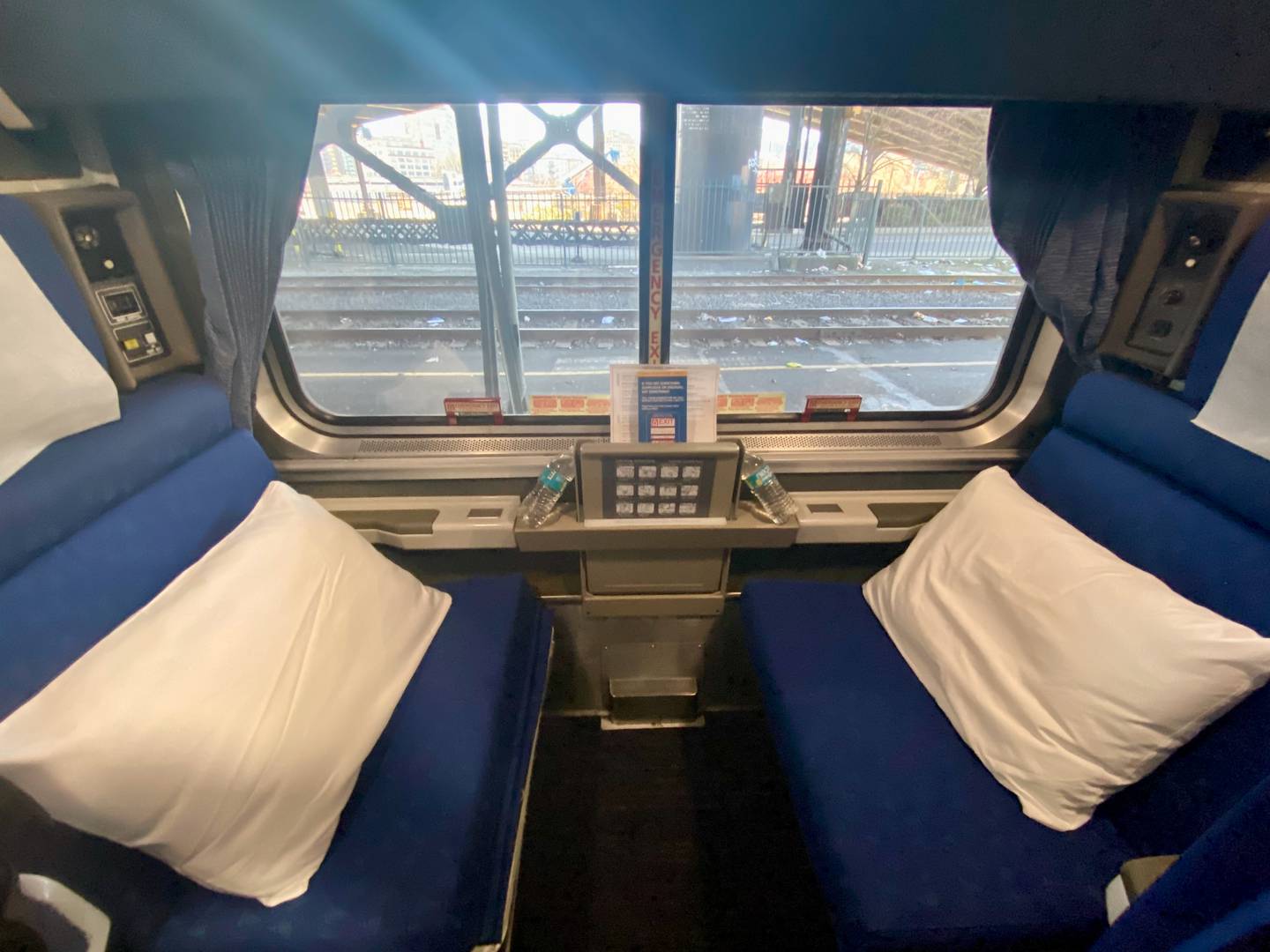 a train car roomlette featuring two seats facing each other on either side of a large window