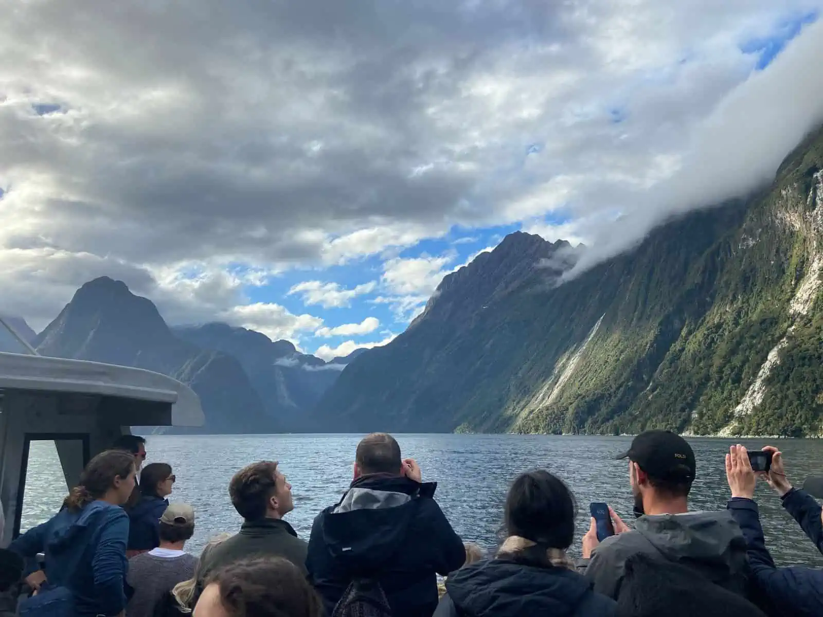 crowds taking photos on a milford sound cruise in New Zealand, milford sound vs doubtful sound