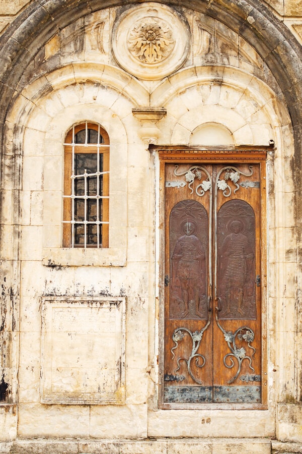 An ornate wooden door at Gelati Monastery in Kutaisi.