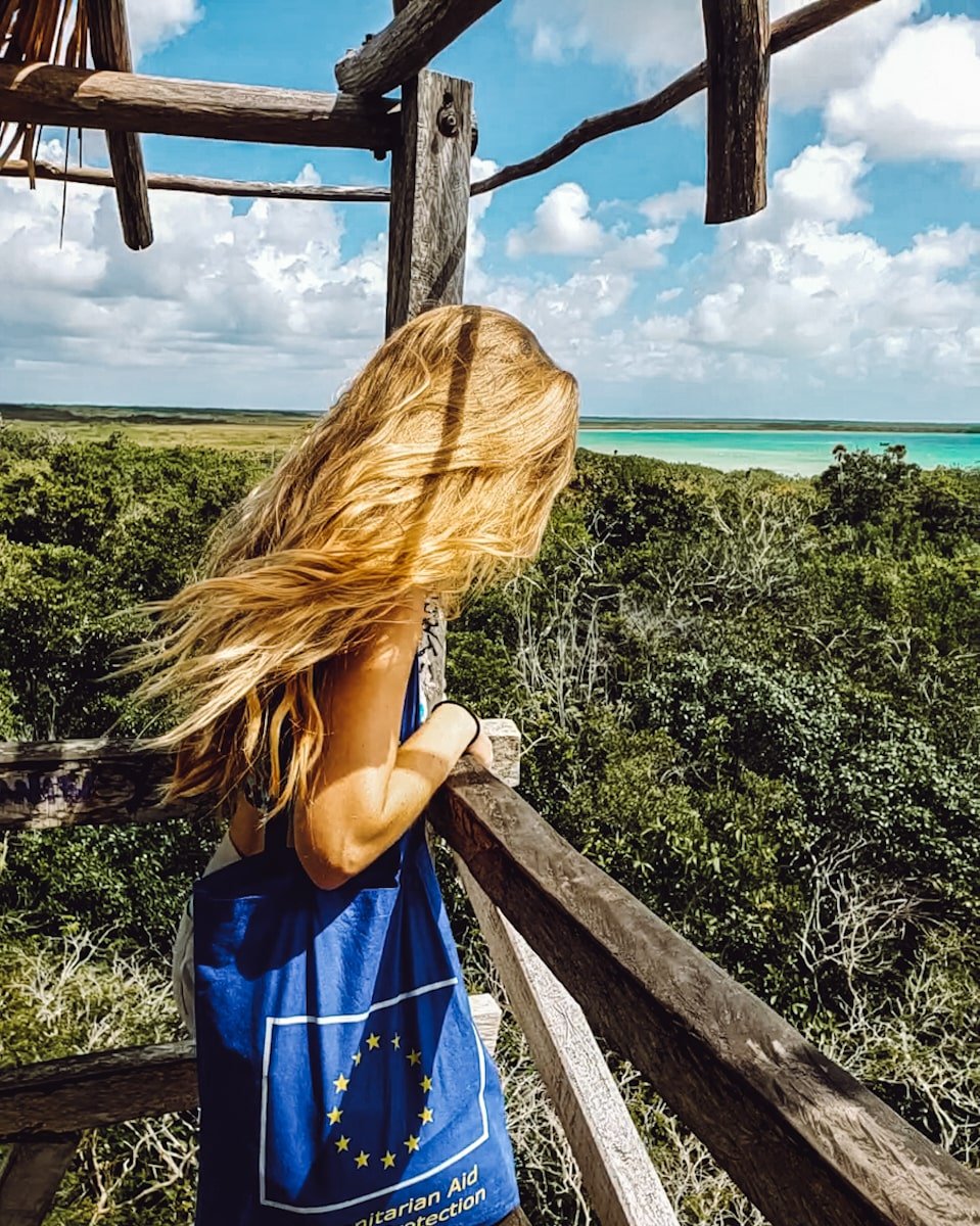 Woman overlooking Sian Ka'an Biosphere Reserve and Muyil lagoon at the Muyil observation tower.