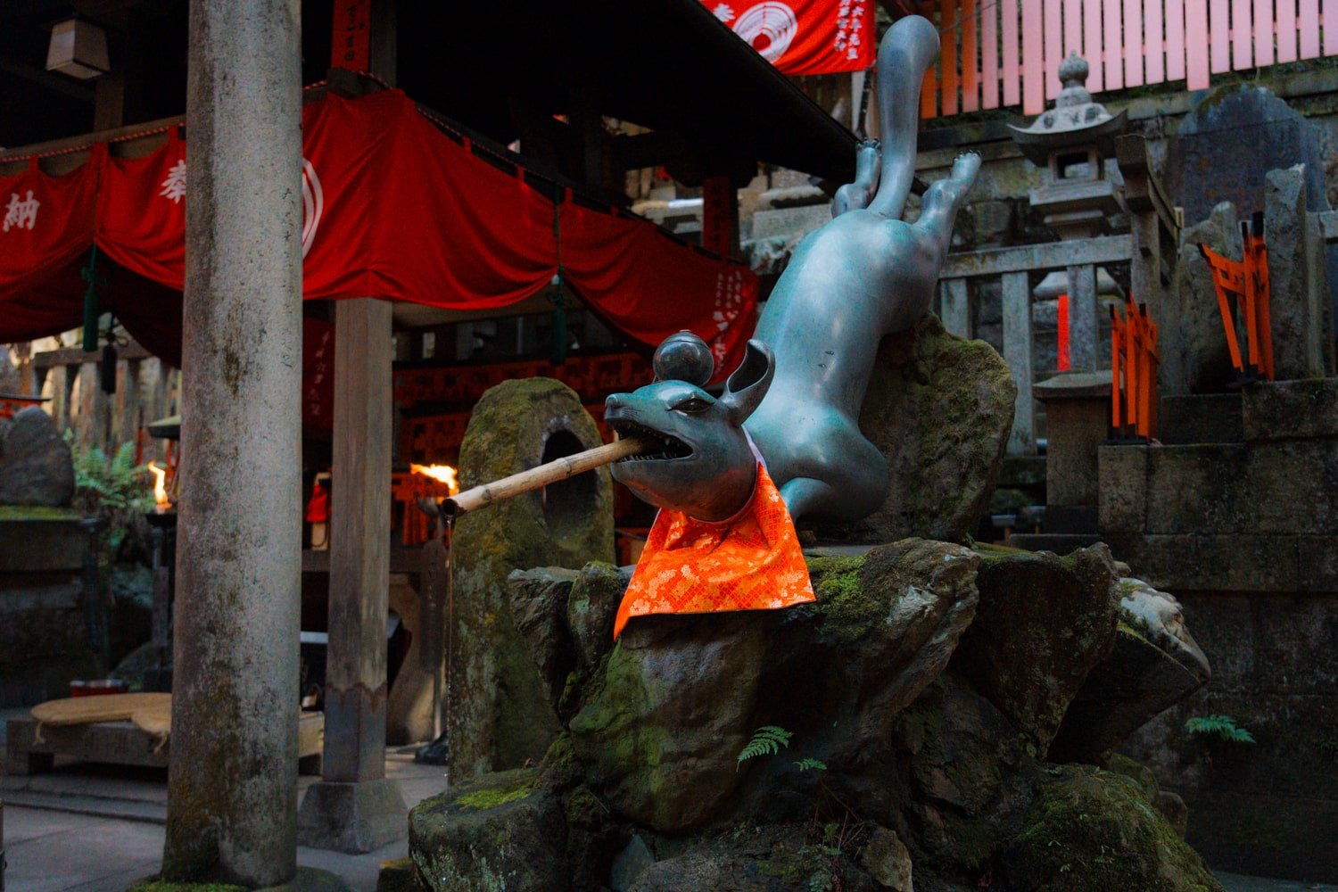 Okami Inari statue and wash basin on the Fushimi Inari Shrine trail, Kyoto, Japan.