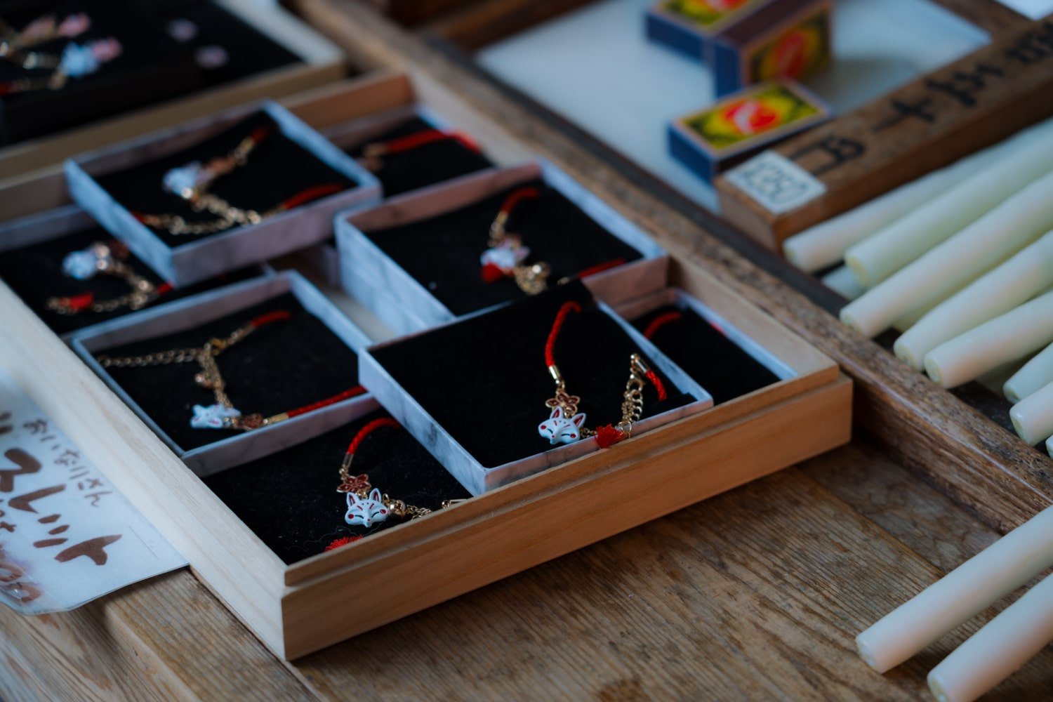 Inari (fox) charms and fortunes at the Fushimi Inari Sharine in Kyoto, Japan.