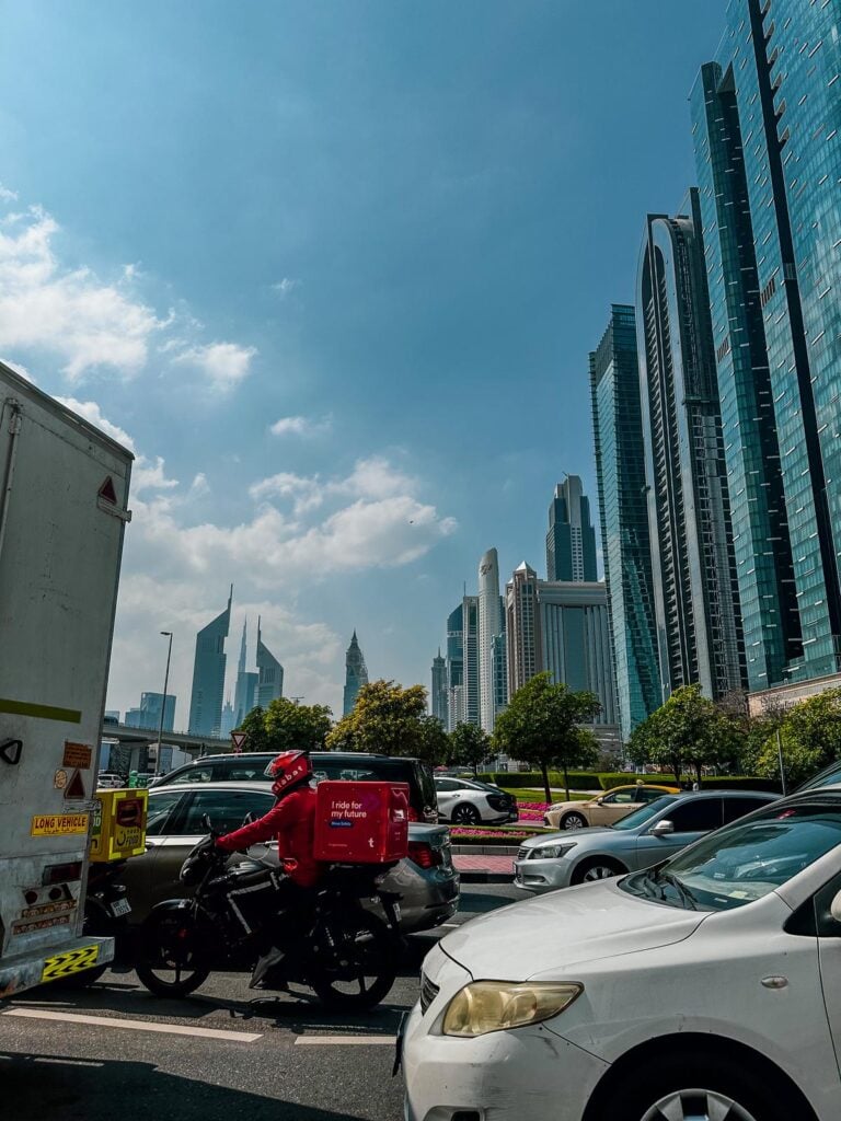 Traffic congestion in downtown Dubai showcasing skyscrapers and bustling city life.