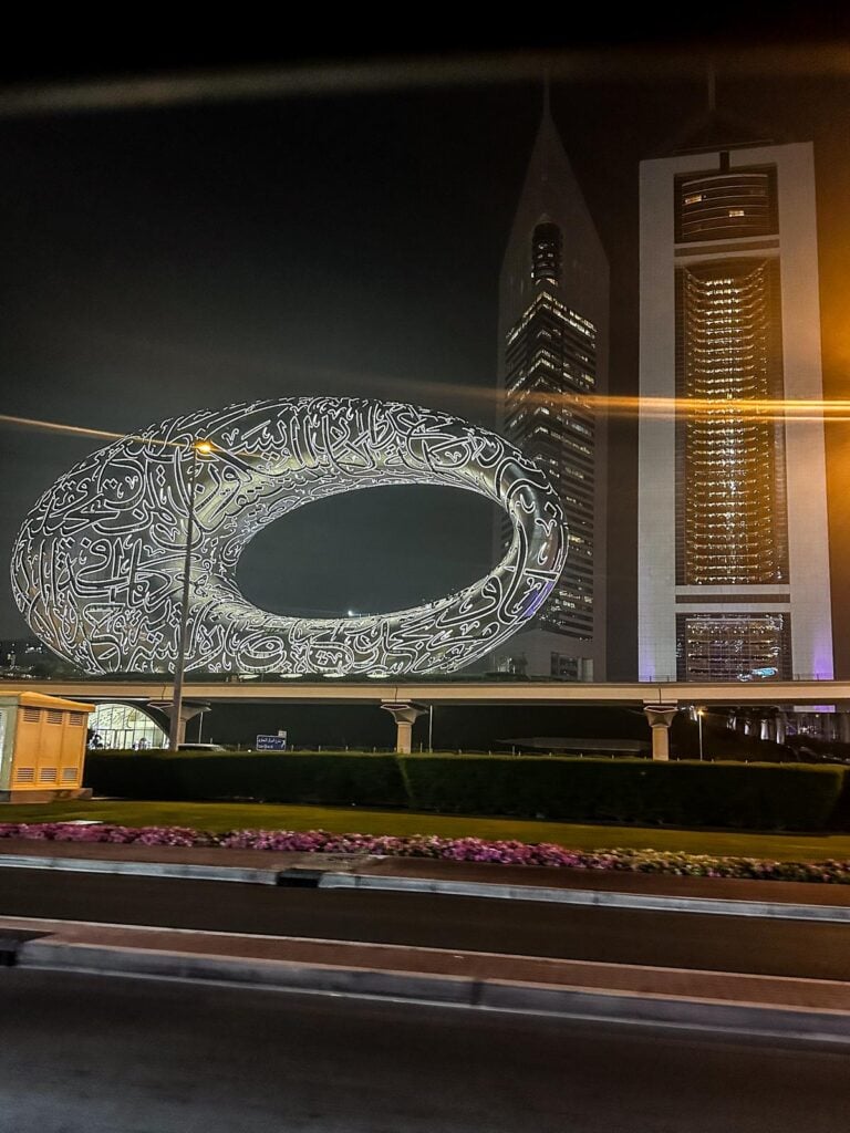 Captivating night view of Museum of the Future in Dubai, showcasing futuristic design and illuminated calligraphy.