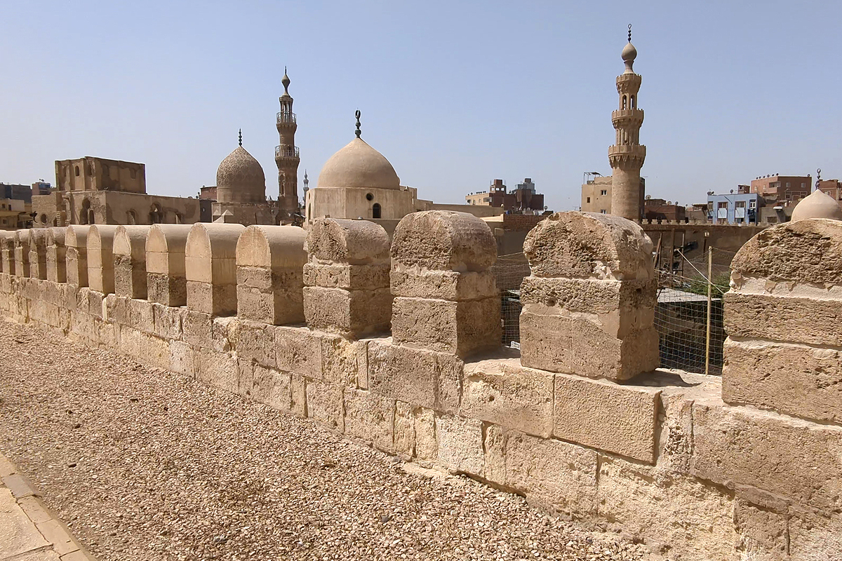 The Ayyubid Wall in Azhar Park rises up over a cluster of domes and minarets. 