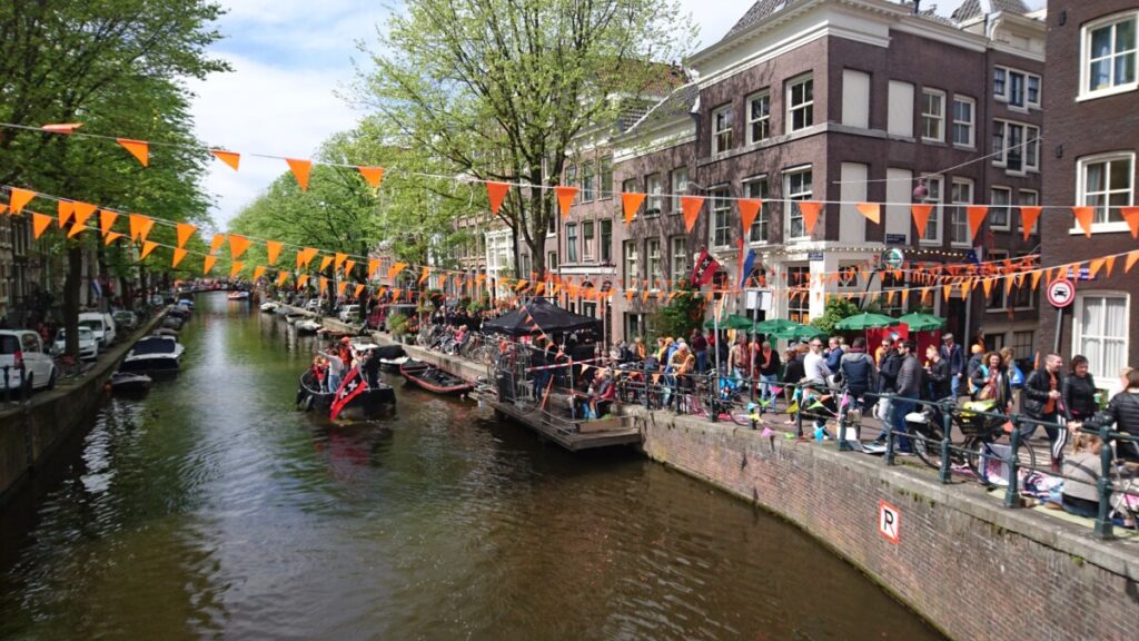 Streamers and Boats on King's Day in Jordaan Amsterdam