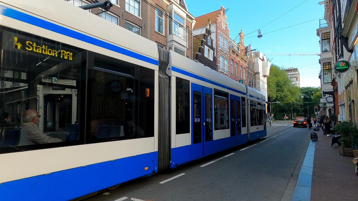 Blue and white Amsterdam tram en route to Station RAI