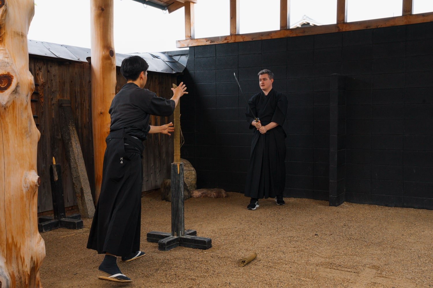 A katana sword expert places tatami roll for tourist to slice through using katana sword during Kyoto Samurai Experience.