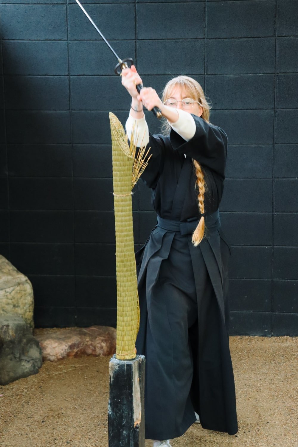 Bucketlist Bri travel blogger wielding a katana sword during Kyoto Samurai Experience.