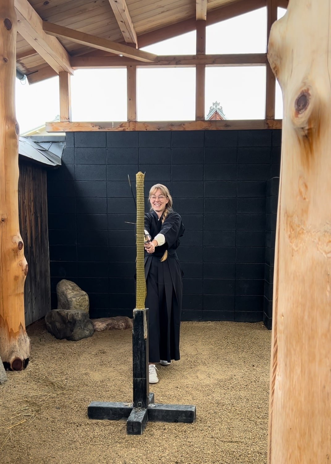 Bucketlist Bri travel blogger wielding a katana sword during Kyoto Samurai Experience.