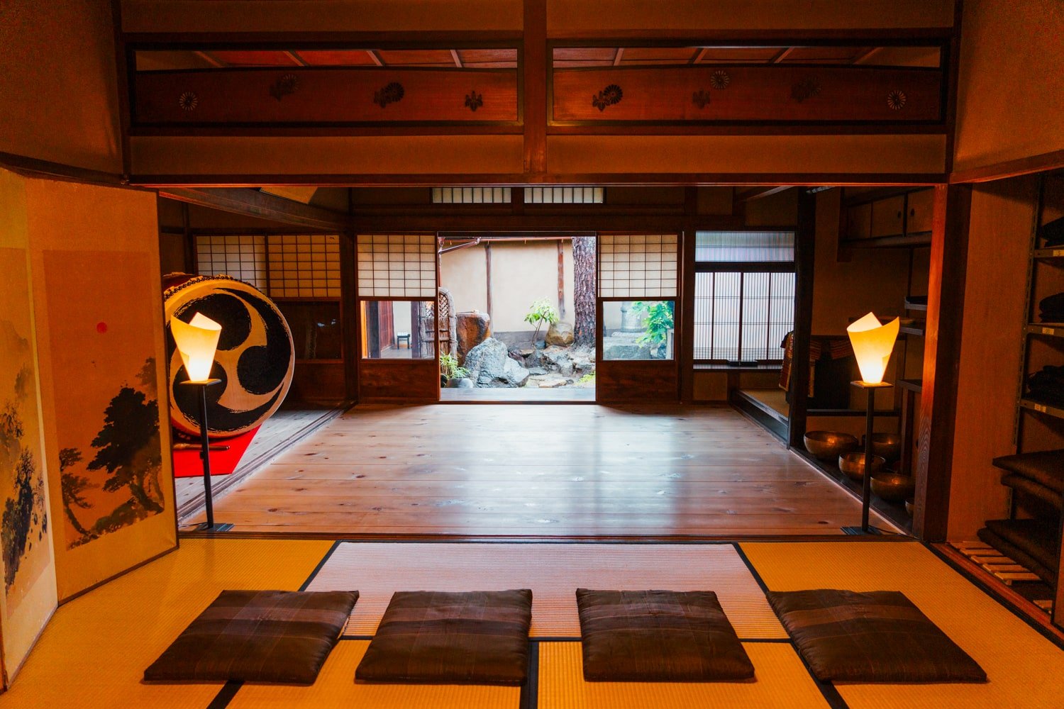 A traditional tatami room with cushions and wooden floor for hosting samurai katana demonstrations inside former samurai's home in Kyoto, Japan.