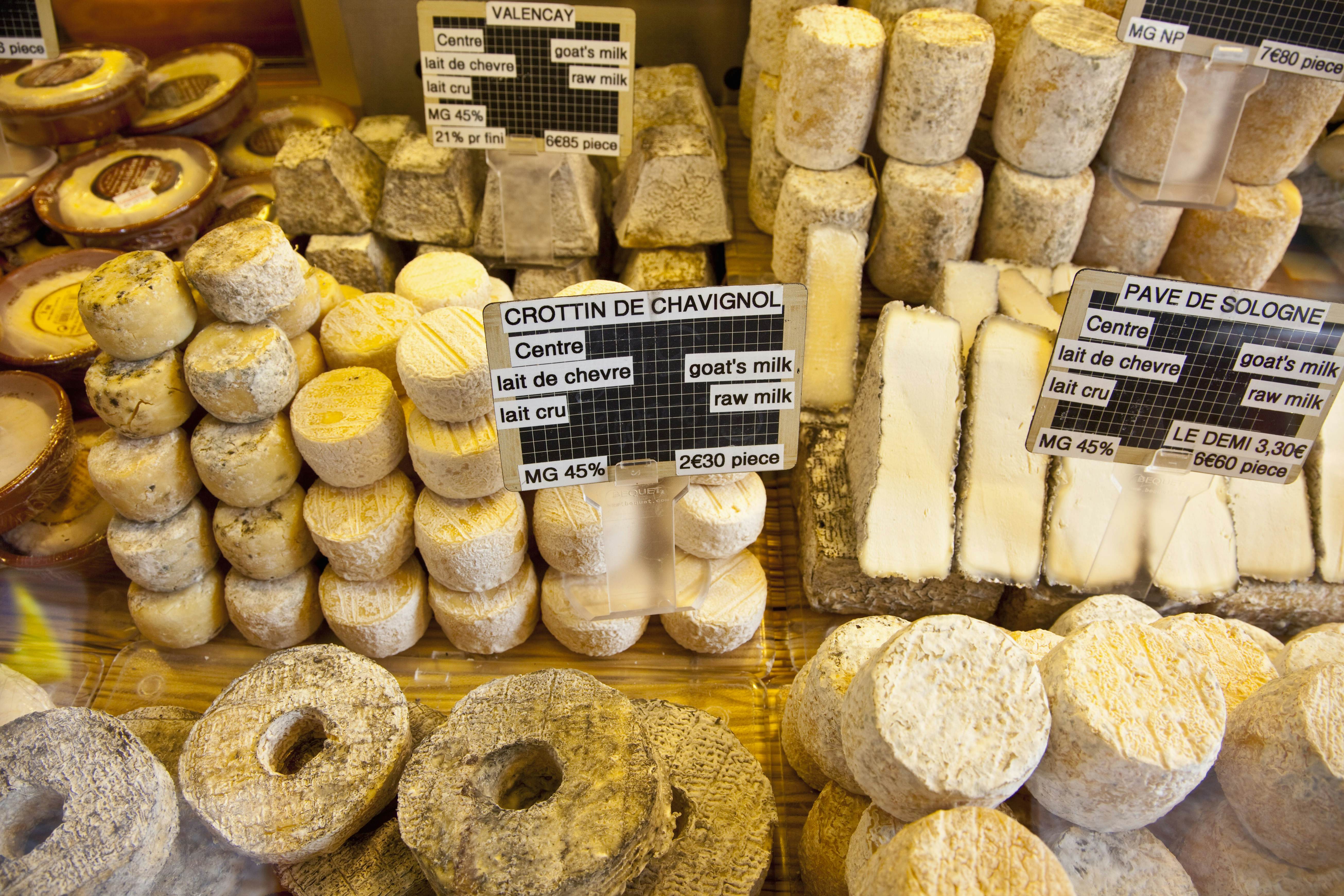 Various kinds of cheese for sale at a street market on Rue Mouffetard in Paris