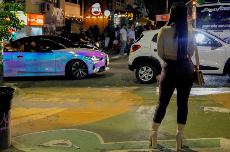 A woman stands on a street in Medellin, Colombia, where the mayor has issued two decrees in a bid to crack down on sex tourism (Fredy Builes)