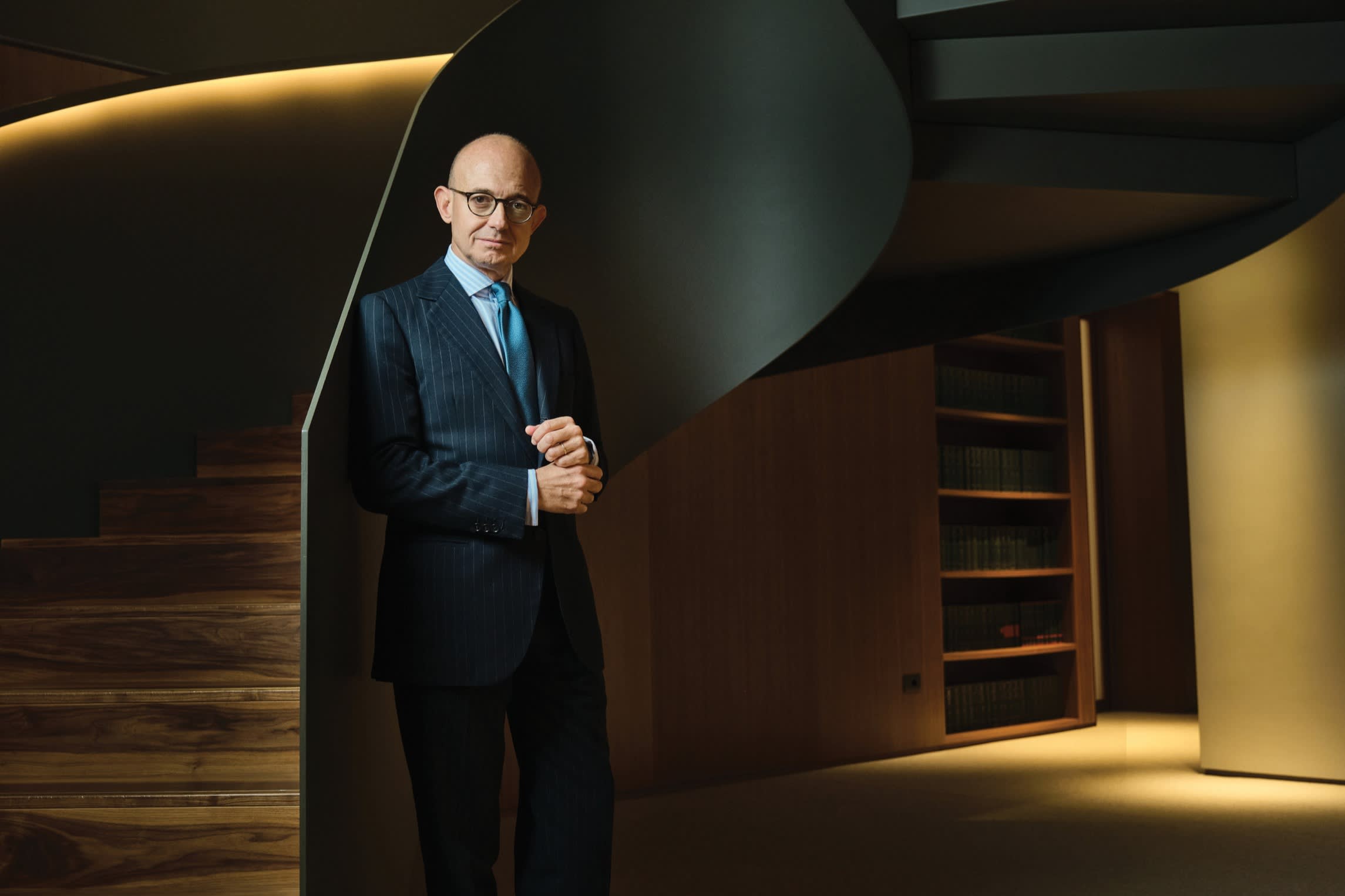 Marco Cerrato, lawyer, LL.M, partner of Maisto Associati in Maisto Associati headquarters in Milan, poses for the camera while in a darkkened room