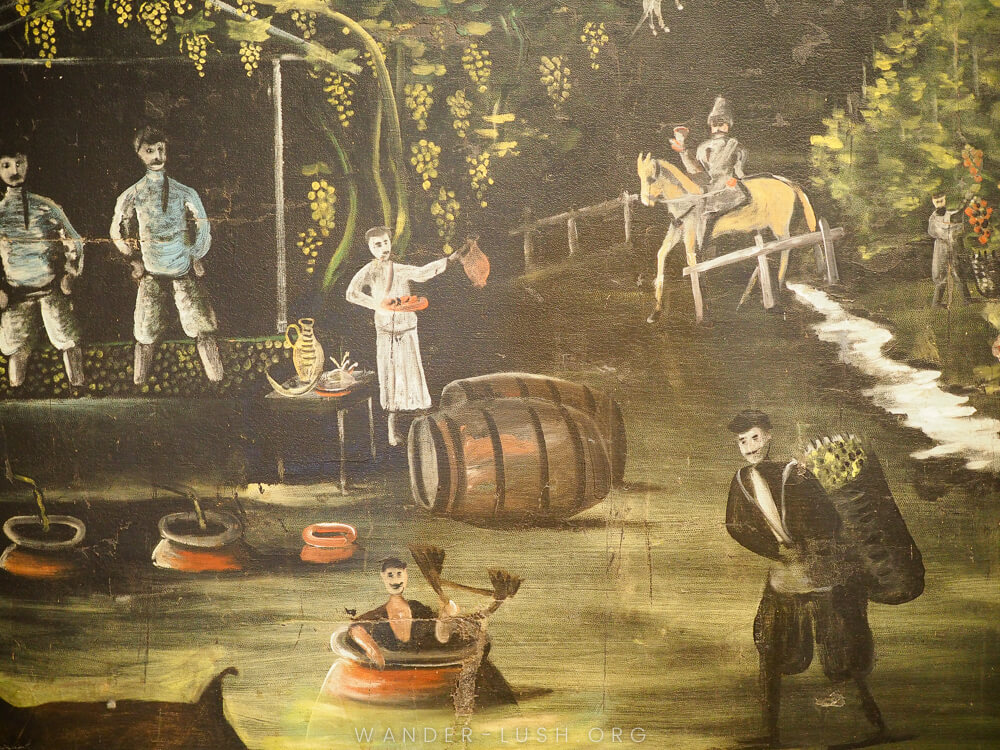 A painting depicting people with wine barrels and food.