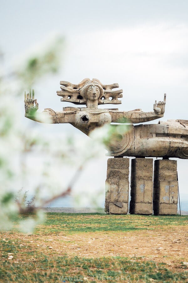 Peace by Nugzar Manjaparashvili, a Soviet concrete statue in Kakheti of a woman outstretched.