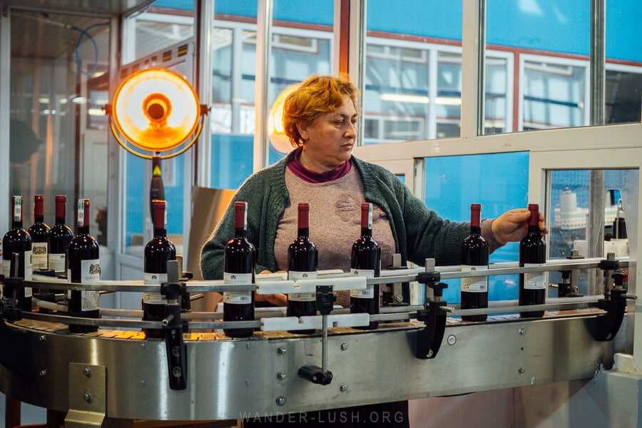 A woman bottling Georgian wine at Kindzmarauli.